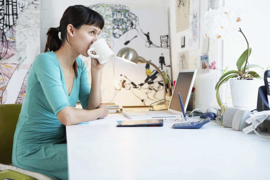 Woman at Desk working remotely on her laptop